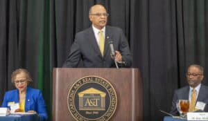 Elevated speaker at a conference on real estate development in North Carolina.