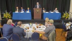 Panel discussion at CAES News conference with speakers and audience.