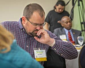 Business conference attendee deep in thought during a professional event.