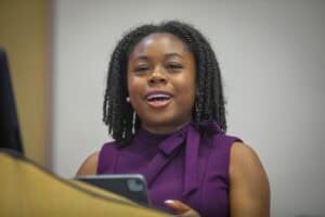 Engaged African American woman speaking at a professional event or meeting.