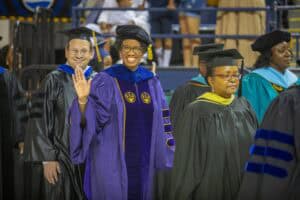 Graduates in academic regalia at a graduation ceremony celebrating achievement and academic success.