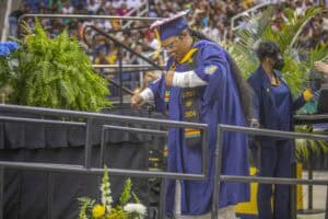 Graduation ceremony with students in caps and gowns celebrating academic achievement at CAES News ev.
