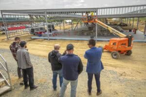 Elevator construction site with workers and machinery under development.