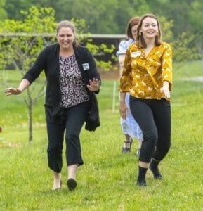 Enjoying outdoor activities at CAES News event with friends in a lush green park.
