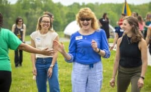 Enjoying outdoor community event with smiling women and friendly interactions.