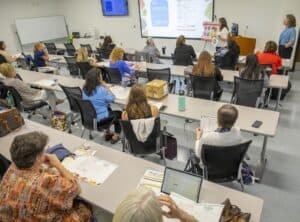 Classroom training session with students and instructor at the front.