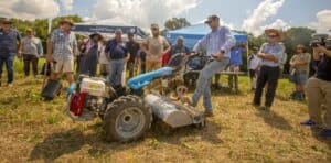 Agricultural machinery demonstration at CAES News event with farmers and experts.