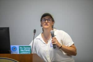 Advocate speaking at a conference about sustainable farming and food security.