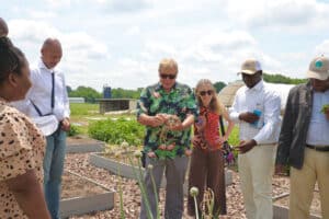 Community leaders visit urban farm for sustainable agriculture initiatives.