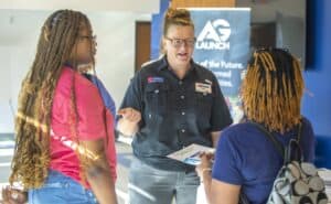 Women engaging in a discussion at CAES News event, technology and education focus.