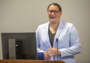 Professional woman giving a presentation at a conference or seminar.