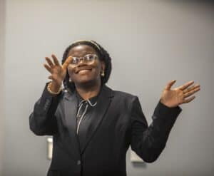 Empowered woman speaking confidently at a professional event or conference.