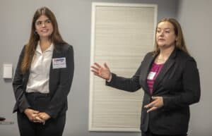 A woman presenting during a professional conference or seminar.