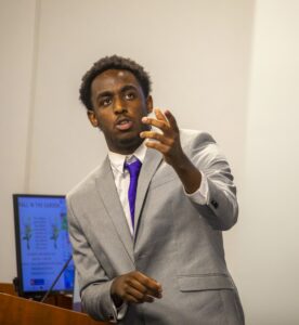 Engaged professional man giving presentation in business meeting or conference.
