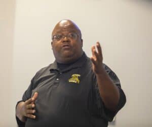 Elevated man speaking passionately during a presentation or meeting.
