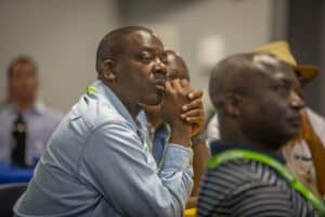 Africa conference attendee listening attentively at a professional event.