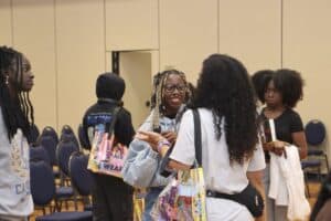 Group of young women engaging and networking at a career fair event.