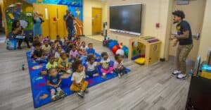 Children attending an educational activity in a classroom setting.