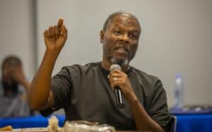 Empowered speaker at conference sharing insights with audience for community development.