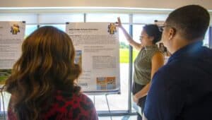SECU student presenting research poster at academic conference.