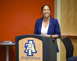Empowered woman speaking at North Carolina Agricultural and Technical State University event.