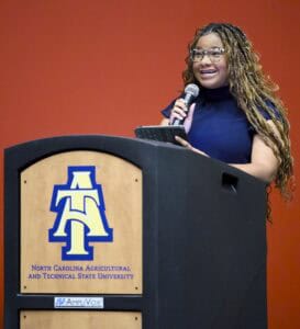Empowered woman speaking at North Carolina Agricultural and Technical State University event.