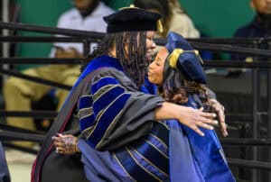 Graduates embracing during a graduation ceremony at CAES News.