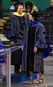 Graduation ceremony with graduates in academic regalia celebrating achievement at CAES News event.