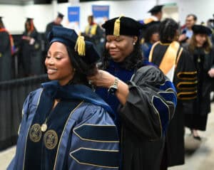 Graduates in academic regalia at a graduation ceremony celebrating higher education achievements.