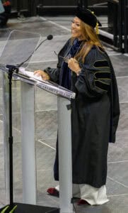 Graduation speaker at commencement ceremony in academic regalia.
