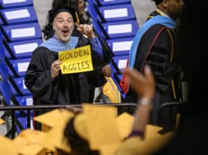 Genuine excitement at graduation ceremony with graduates in caps and gowns celebrating success.