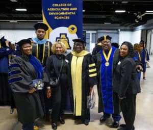 Graduates in academic regalia at College of Agriculture and Environmental Sciences graduation ceremo.